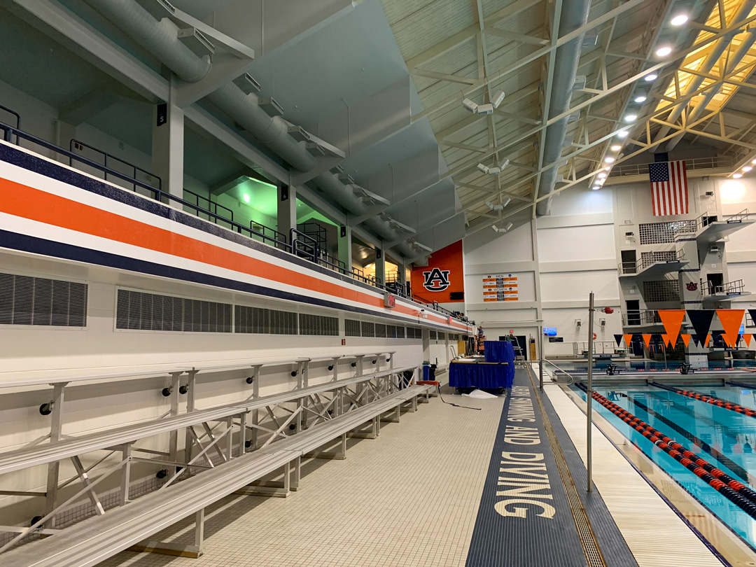 Dimensional Auburn logo and power stripe in the pool deck of the Auburn Aquatics Center designed by Formula Design